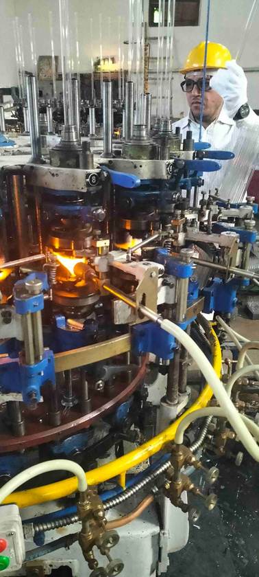 Quality control staff monitoring the ampoule forming line at our Sirsa factory